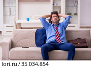 Young male employee being fired from his work at home. Стоковое фото, фотограф Elnur / Фотобанк Лори