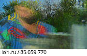 Отражение пассажира в окне купейного вагона на фоне меняющегося пейзажа. Reflection of a traveler in the window of a compartment car against the background of a changing landscape. Стоковое видео, видеограф Владимир Литвинов / Фотобанк Лори