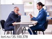 Yound and old employees in business presentation concept. Стоковое фото, фотограф Elnur / Фотобанк Лори