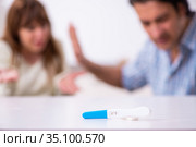 Young couple in unexpected pregnancy concept at home. Стоковое фото, фотограф Elnur / Фотобанк Лори
