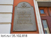 Информационная каменная табличка "Российская академия живописи, ваяния и зодчества, Уральский филиал" на фасаде здания в центре города Перми (2020 год). Редакционное фото, фотограф Юрий Карачев / Фотобанк Лори