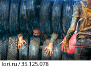 Russia, Samara, June 2019: athletic youth participates in a race of heroes and overcomes obstacles car tires on a summer day in the village of Roshchinsky . Text in Russian: race of heroes, platoon. Стоковое фото, фотограф Акиньшин Владимир / Фотобанк Лори