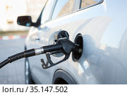 Gas pump inserted into car petrol tank, close-up view, nobody. Diesel refueling. Стоковое фото, фотограф Кекяляйнен Андрей / Фотобанк Лори