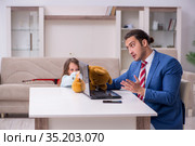 Girl bothering young father during working from house in pandemi. Стоковое фото, фотограф Elnur / Фотобанк Лори