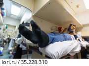 Male legs in black socks in the aisle of a train car. Стоковое фото, фотограф Володина Ольга / Фотобанк Лори