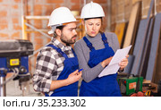 Disgruntled foreman discussing drawing with worker. Стоковое фото, фотограф Яков Филимонов / Фотобанк Лори