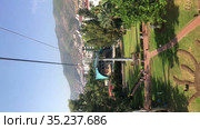 Cabin of cableroad starts moving from lower station located in the Kleopatra beach. Ropeway to the Castle of Alanya with picturesque views at the Mediterranean sea. Turkey (2021 год). Редакционное видео, видеограф Кекяляйнен Андрей / Фотобанк Лори