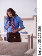 Young male employee being fired from his work at home. Стоковое фото, фотограф Elnur / Фотобанк Лори