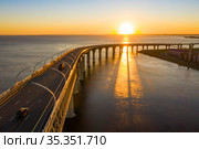High-speed toll road, highway bypassing the city center St. Petersburg, the central section of the western high-speed section. A beautiful sunset over the Gulf of Finland. Стоковое фото, фотограф Mikhail Starodubov / Фотобанк Лори