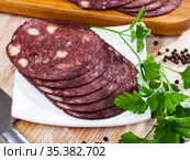 black puddingon served with parley on plate on wooden table. Стоковое фото, фотограф Яков Филимонов / Фотобанк Лори