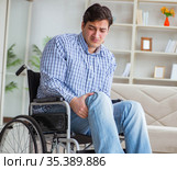 Disabled young man suffering at home. Стоковое фото, фотограф Elnur / Фотобанк Лори