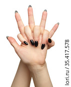 Female hands with black nails manicure isolated on white background. Стоковое фото, фотограф Сергей Пристяжнюк (Serg Zastavkin) / Фотобанк Лори