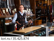 Gun store salesman showing collectible rifled musket. Стоковое фото, фотограф Яков Филимонов / Фотобанк Лори