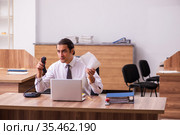 Young male employee unhappy with office prank in the office. Стоковое фото, фотограф Elnur / Фотобанк Лори