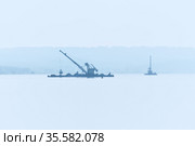 Dredgers is working to deepen the fairway on the river in the morning fog. Стоковое фото, фотограф Евгений Харитонов / Фотобанк Лори