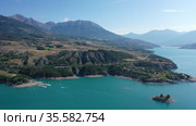 Serene summer landscape of Lake Serre-Poncon, artificial lake surrounded by French Alps, Provence-Alpes-Cote d Azur region. Стоковое видео, видеограф Яков Филимонов / Фотобанк Лори