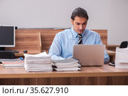 Young male employee unhappy with excessive work. Стоковое фото, фотограф Elnur / Фотобанк Лори