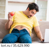 Man suffering from extra kilos in dieting concept. Стоковое фото, фотограф Elnur / Фотобанк Лори