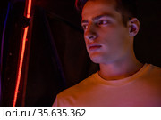 Portrait of attractive young man in neon lighting. Стоковое фото, фотограф Женя Канашкин / Фотобанк Лори