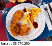 Crisp chicken nuggets with golden brown crust and french fries. Стоковое фото, фотограф Яков Филимонов / Фотобанк Лори