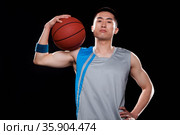 Portrait of basketball player, black background. Стоковое фото, агентство Ingram Publishing / Фотобанк Лори