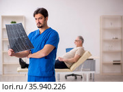 Old male patient visting young male doctor radilogist. Стоковое фото, фотограф Elnur / Фотобанк Лори