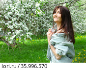 Beautiful young woman with cherry flowers in spring garden. Стоковое фото, фотограф ElenArt / Фотобанк Лори