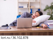 Young male employee in oversleeping concept. Стоковое фото, фотограф Elnur / Фотобанк Лори