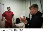 Врач освидетельствует задержанного полицейскими в травматологической поликлинике Балашихи (2021 год). Редакционное фото, фотограф Дмитрий Неумоин / Фотобанк Лори