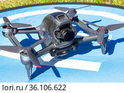 Moscow Russia - 30 may 2021: Close-up picture new aerial DJI FPV drone on fly landing pad. Top front view uav quad copter with 4K 60 fps Digital Camera and Remote control. travel in sunny summer day. Редакционное фото, фотограф Алексей Ширманов / Фотобанк Лори