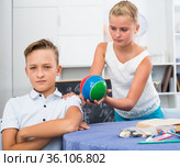 Girl is excusing for the offendedly boy and offering to play ball. Стоковое фото, фотограф Яков Филимонов / Фотобанк Лори