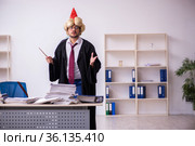 Funny young male employee magician and too much work in the office. Стоковое фото, фотограф Elnur / Фотобанк Лори