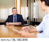 Businessman discussing partnership documents with female partner. Стоковое фото, фотограф Яков Филимонов / Фотобанк Лори