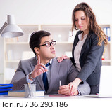 Sexual harassment concept with man and woman in office. Стоковое фото, фотограф Elnur / Фотобанк Лори