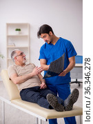 Old male patient visting young male doctor radilogist. Стоковое фото, фотограф Elnur / Фотобанк Лори