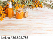 Hippophae homemade sea buckthorn oil in glass bottles with a pipette on the background with copy space, alternative herbal medicine and cosmetology. Стоковое фото, фотограф Светлана Евграфова / Фотобанк Лори