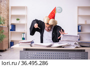 Funny young male employee magician and too much work in the office. Стоковое фото, фотограф Elnur / Фотобанк Лори