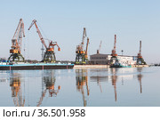 Port cranes stand at the pier in Ruse port, Danube river (2014 год). Стоковое фото, фотограф EugeneSergeev / Фотобанк Лори