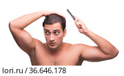 Man brushing his hair isolated on white. Стоковое фото, фотограф Elnur / Фотобанк Лори