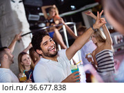 positive male joying and thumbs up on party in the club with coc. Стоковое фото, фотограф Яков Филимонов / Фотобанк Лори