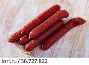 Tyrolean sausages and peppercorns on wooden table. Стоковое фото, фотограф Яков Филимонов / Фотобанк Лори