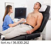 Young woman doctor and patient during the ultrasound examination. Стоковое фото, фотограф Яков Филимонов / Фотобанк Лори