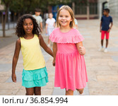 Two young girls walking hand in hand. Стоковое фото, фотограф Яков Филимонов / Фотобанк Лори