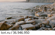 Закат на Черном море. Галечный пляж и скалистые берега. Sunset on the Black Sea. Pebble beach and rocky shores. Стоковое видео, видеограф Евгений Романов / Фотобанк Лори