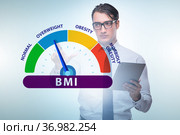 Concept of BMI - body mass index with nutritionist. Стоковое фото, фотограф Elnur / Фотобанк Лори