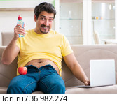 Man suffering from extra kilos in dieting concept. Стоковое фото, фотограф Elnur / Фотобанк Лори
