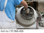 Labore worker operating concrete cement mixer at construction site. Стоковое фото, фотограф Matej Kastelic / Фотобанк Лори