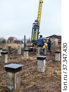 Procces of driving of reinforced precast-concrete piles, ground level works with hammer. Стоковое фото, фотограф Кекяляйнен Андрей / Фотобанк Лори