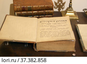 "Книга историография початия имене, славы, и разширения народа славянского И их Царей и Владетелей под многими имянами и со многими Царствиями, Королевствами, и Провинциами". Фрагмент композиции "М.В. Ломоносов и Академия наук XVIII века" в Кунсткамере. Россия, город Санкт-Петербург (2020 год). Редакционное фото, фотограф Щеголева Ольга / Фотобанк Лори