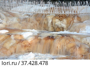 One of the most famous places in the Republic of Karelia is the Ruskeala waterfalls (the filming location of the Soviet film "The Dawns Here Are Quiet...") in the winter season. Traveling in Russia, Republic of Karelia. Стоковое фото, фотограф Алексей Кокоулин / Фотобанк Лори